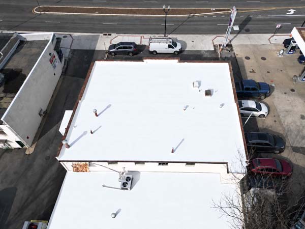 Aerial view of the completed white silicone roof restoration at 2330 Columbia Pike in Arlington, Virginia