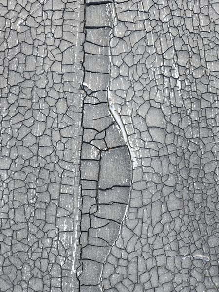 Close-up of severe alligatoring and a split open lap seam in the modified bitumen membrane at 2330 Columbia Pike