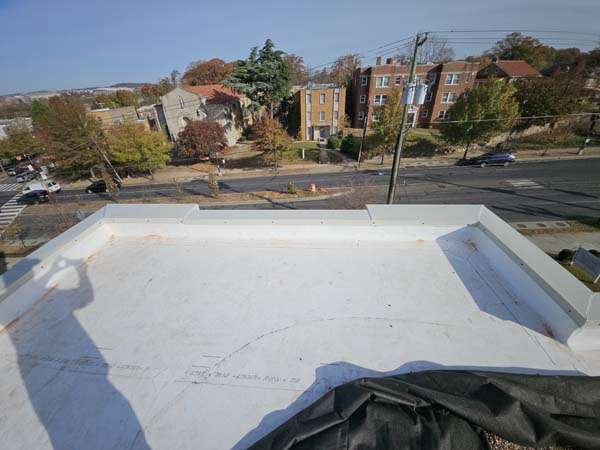 Completed white Elevate UltraPly 60-mil TPO roof at 2801 Pennsylvania Ave SE before the stone ballast was reinstated