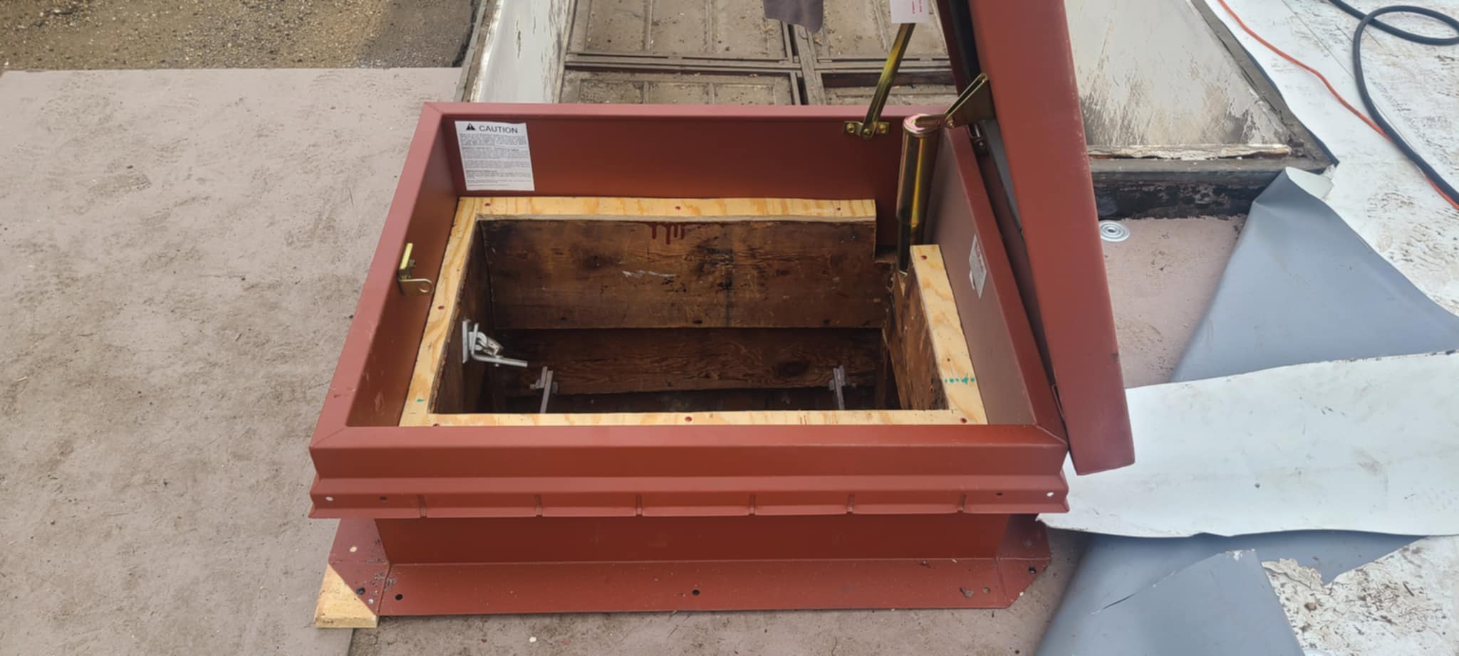 New roof hatch with an insulated curb and new plywood framing set over the original wood joists at 2801 Pennsylvania Ave SE