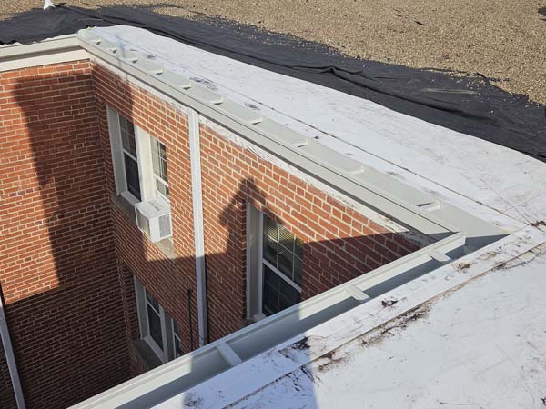 Rebuilt roof edge with new edge metal installed along the reconstructed gutter line at 2801 Pennsylvania Ave SE