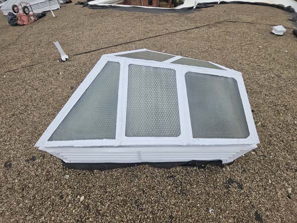 Restored hip-shaped skylight refinished in white on the roof at 2801 Pennsylvania Ave SE