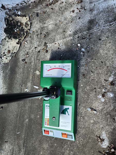 Tramex moisture meter documenting elevated moisture in the existing roof assembly at 633 Pennsylvania Ave NW
